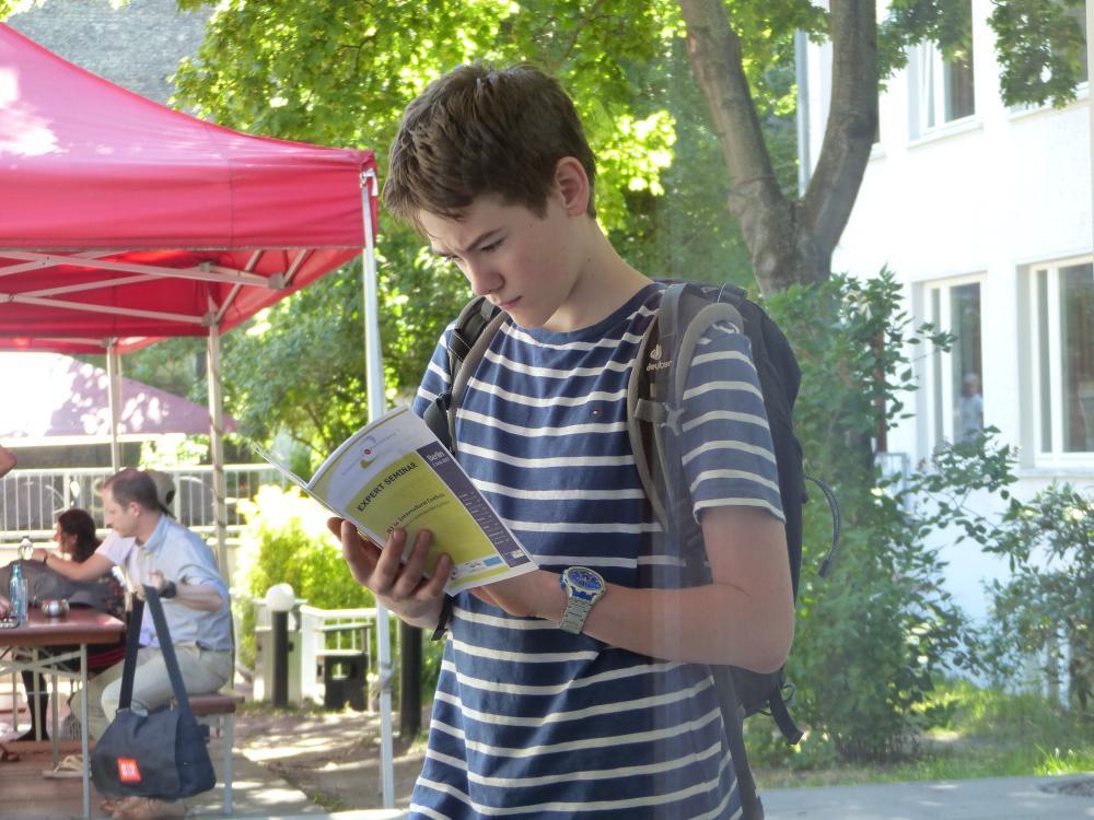 Boy reading a leaflet