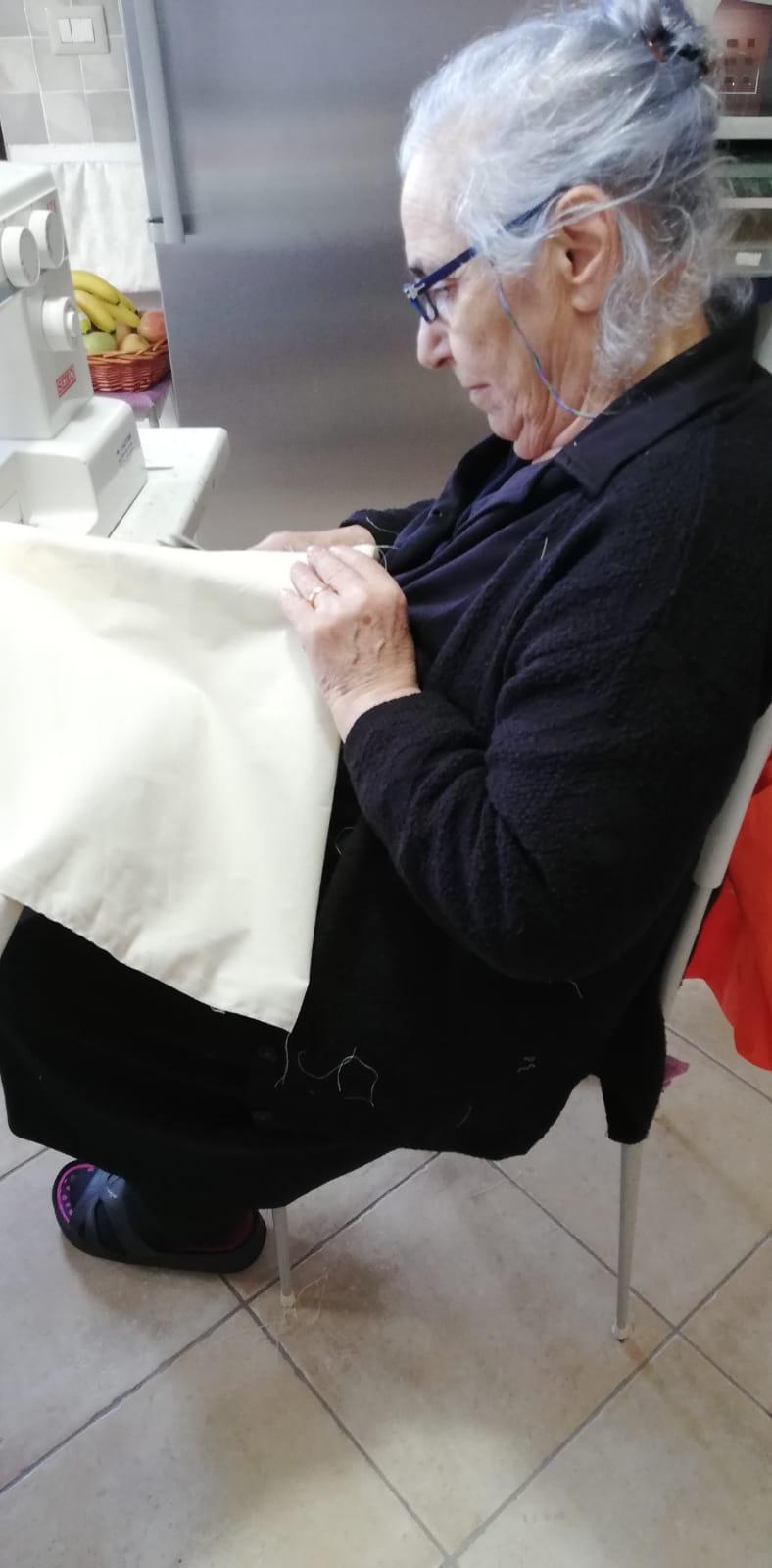 Volunteer in Nuoro sews our conference bags