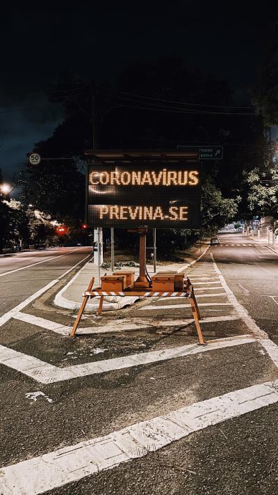Coronavirus warning for cars at a crossroad