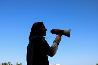 A woman with a megaphone - photo by Juliana Romão